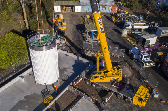 crain carrying big water tank