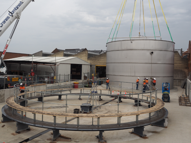 crain carrying big water tank